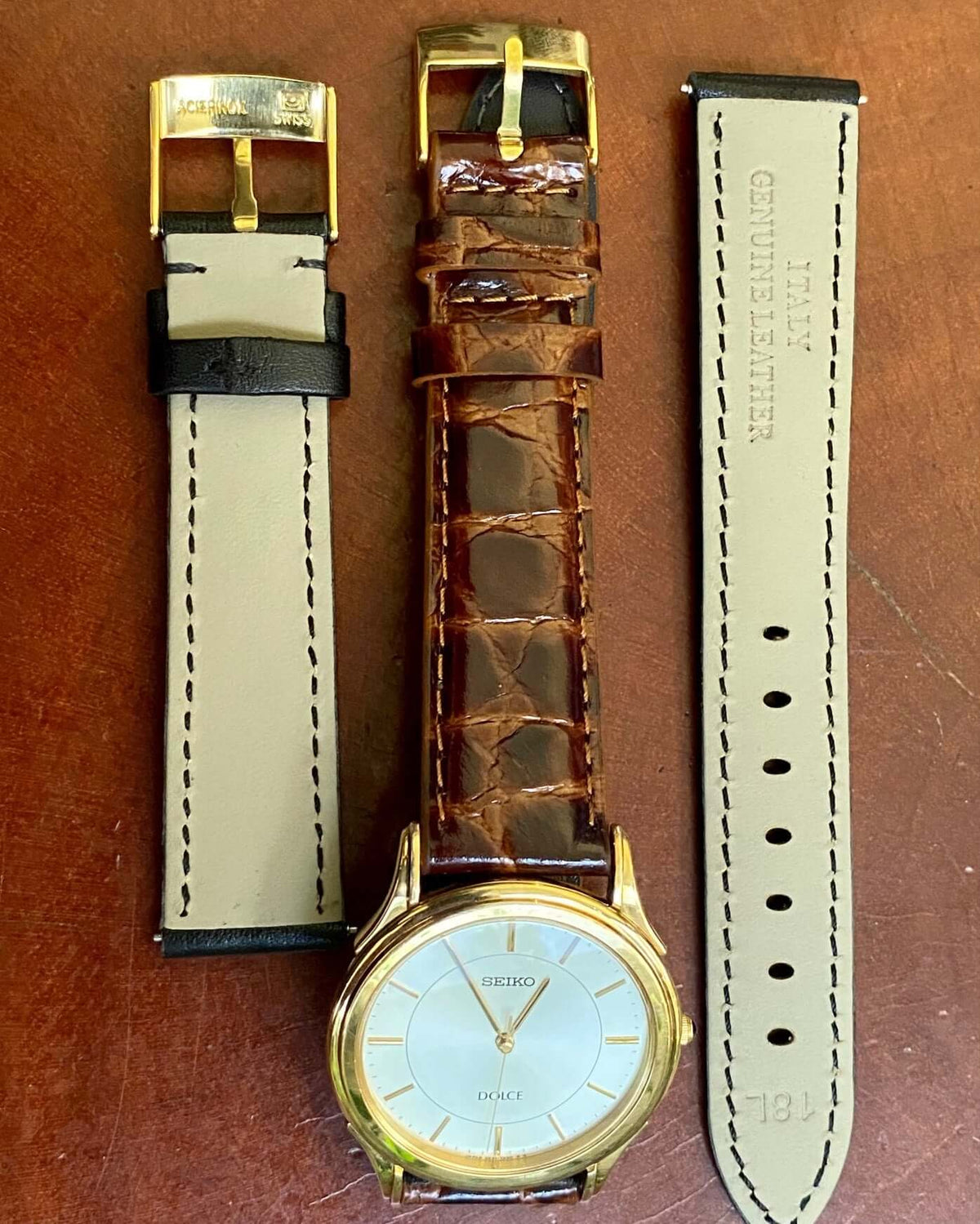 Vintage Seiko Quartz Dolce 5E31-7A40 watch with gold case and brown leather strap on a wooden surface.