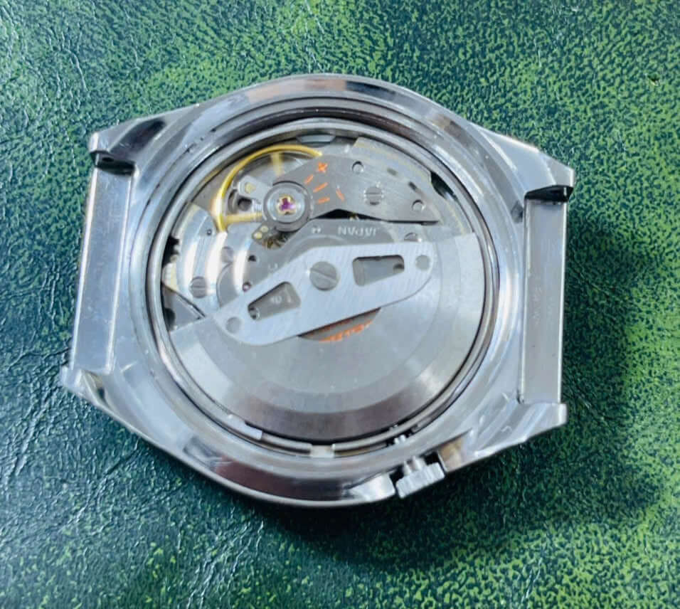 Vintage Seiko 5 Actus 6106-7690 watch movement showing detailed inner mechanics.