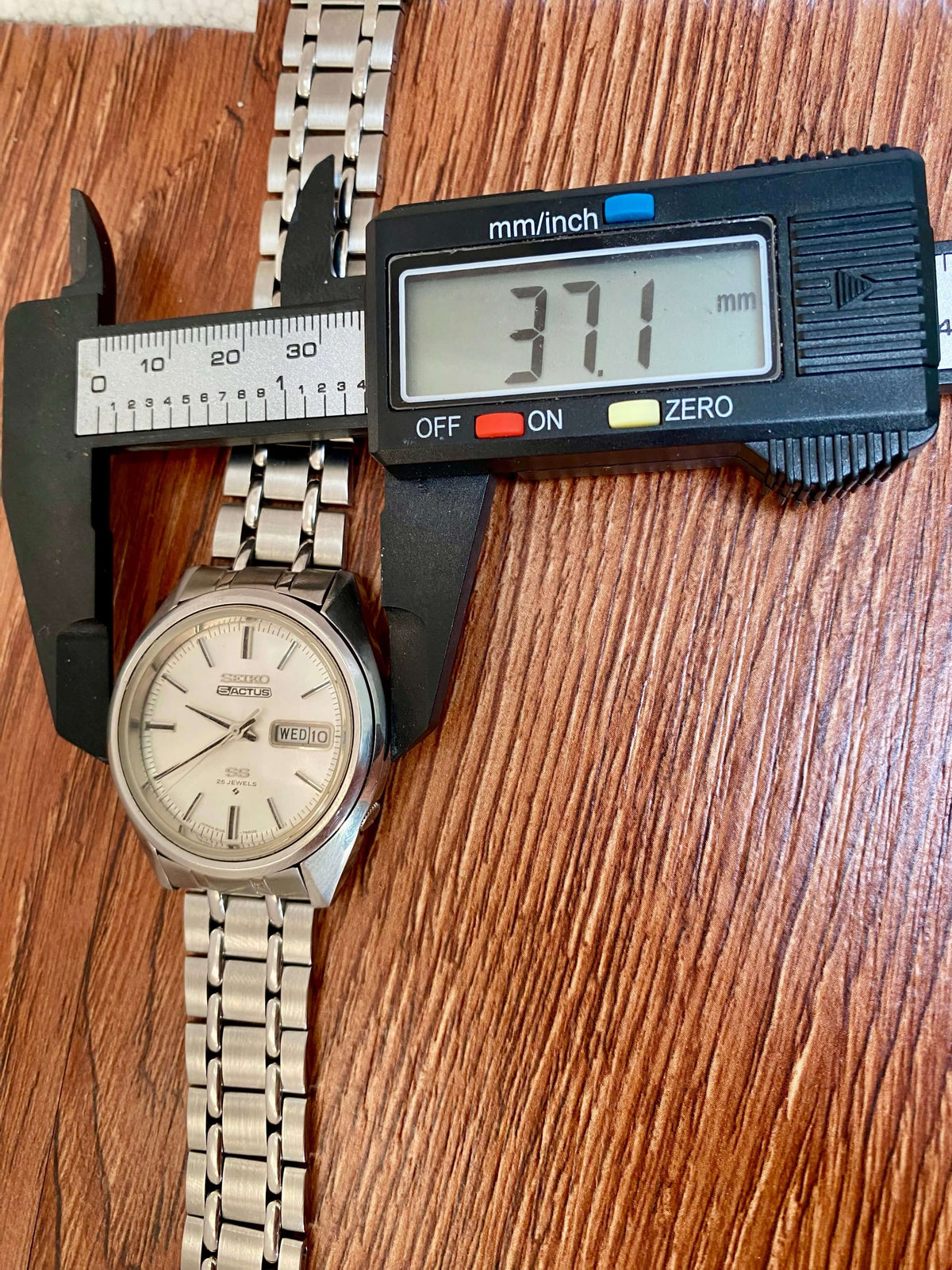 Vintage Seiko 5 SS Actus 6106-7510 measured with caliper for size, showcasing elegant white dial and stainless steel bracelet.