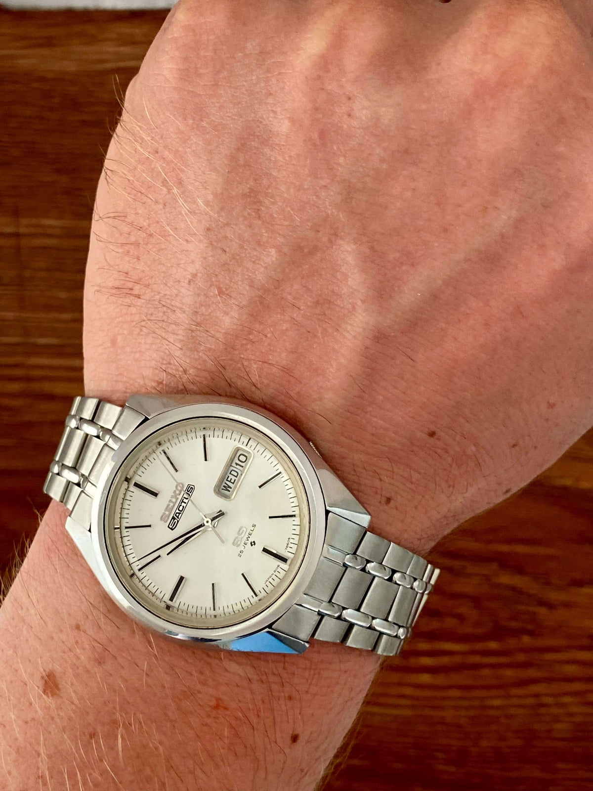 Vintage Seiko 5 SS Actus 6106-7510 worn on wrist, showing white dial and stainless steel bracelet, May 1973.