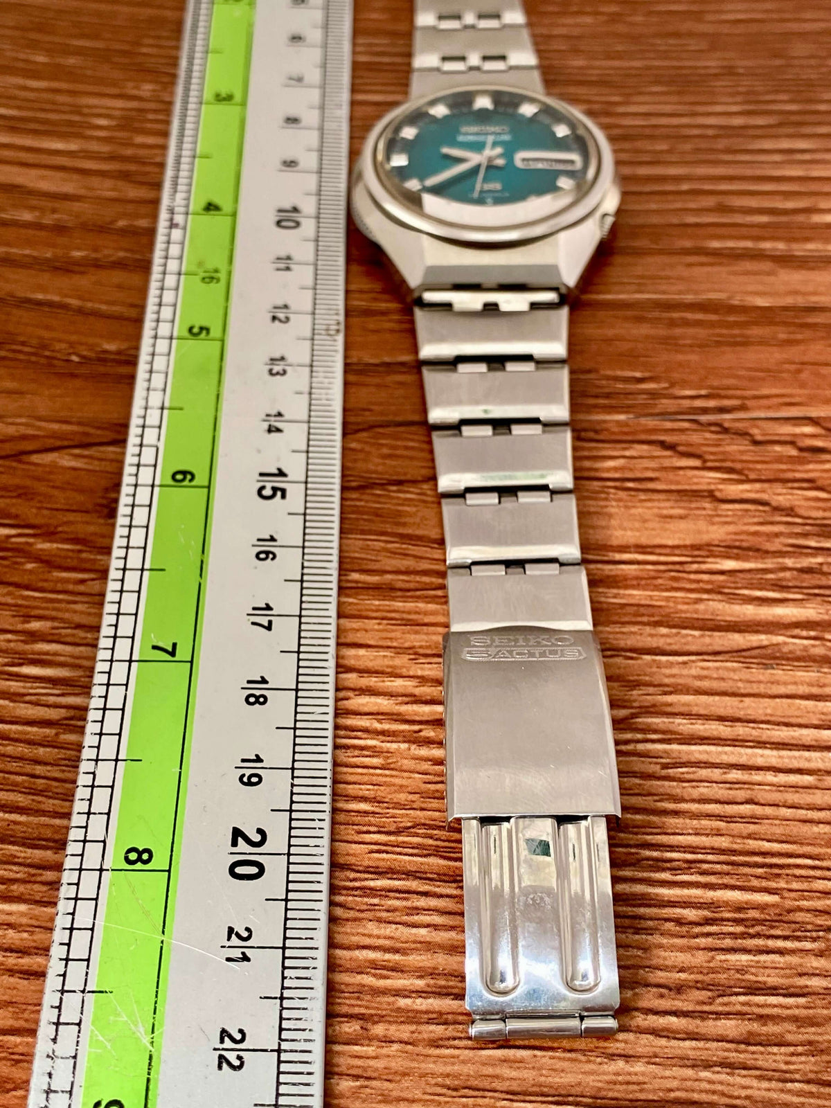 Vintage Seiko 5 Actus 6106-7690 with rare turquoise dial next to a ruler for size reference.