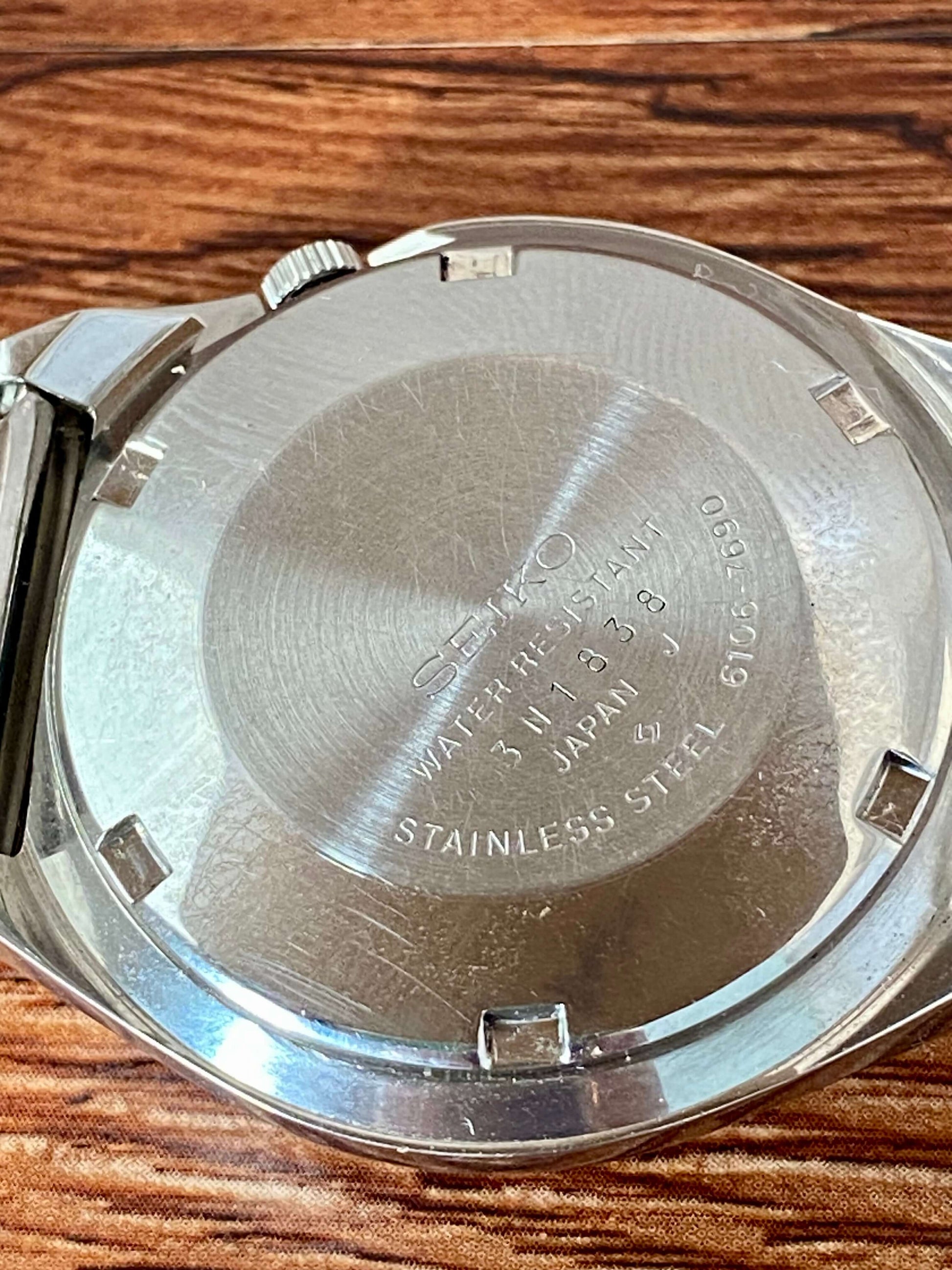 Vintage Seiko 5 Actus 6106-7690 stainless steel case back with engraved details
