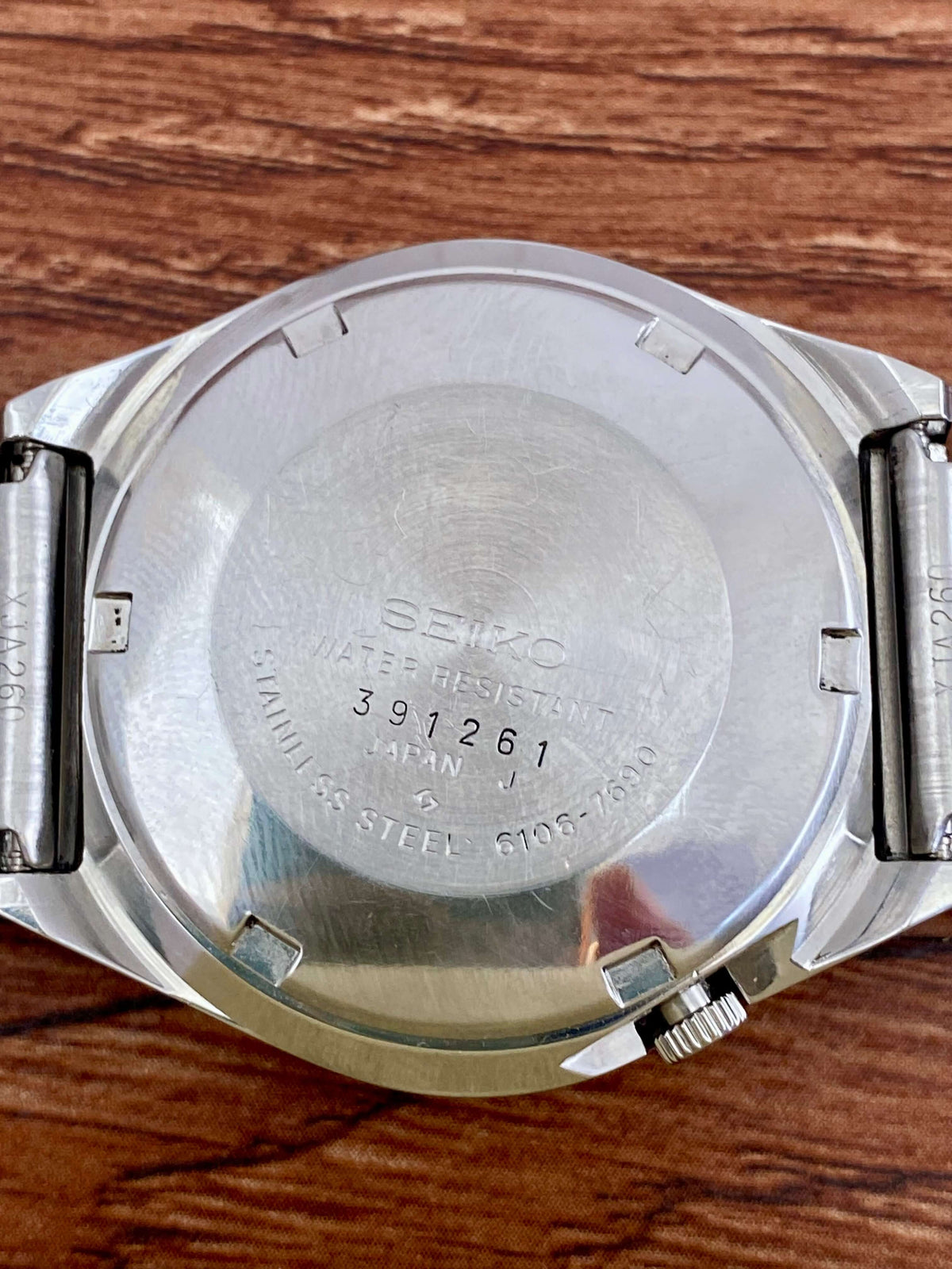 Vintage Seiko 5 Actus 6106-7690 watch case back with serial number 391261, stainless steel finish.