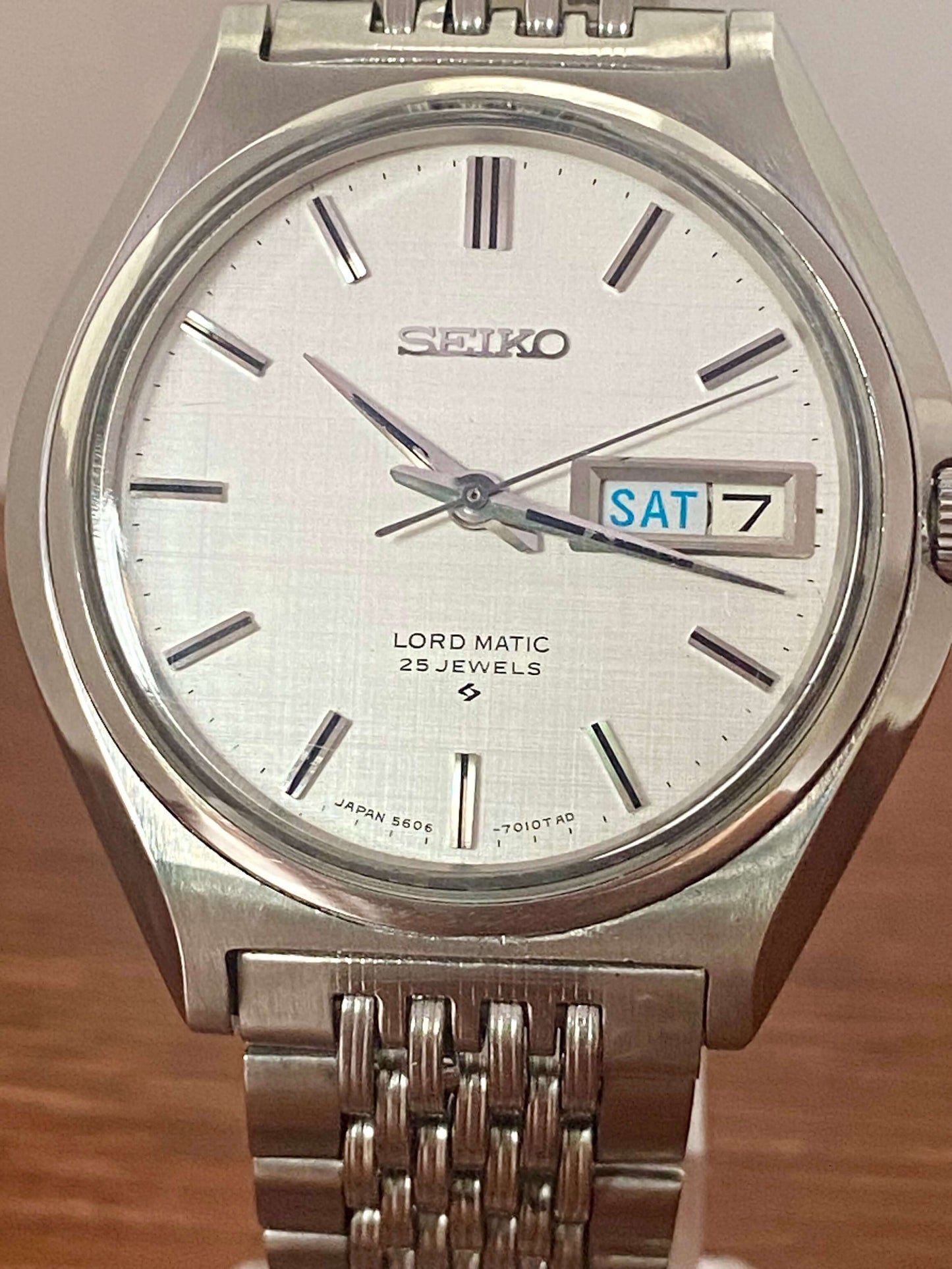 Vintage Seiko Lord Matic 5606-7010 with original white linen dial and day-date feature.
