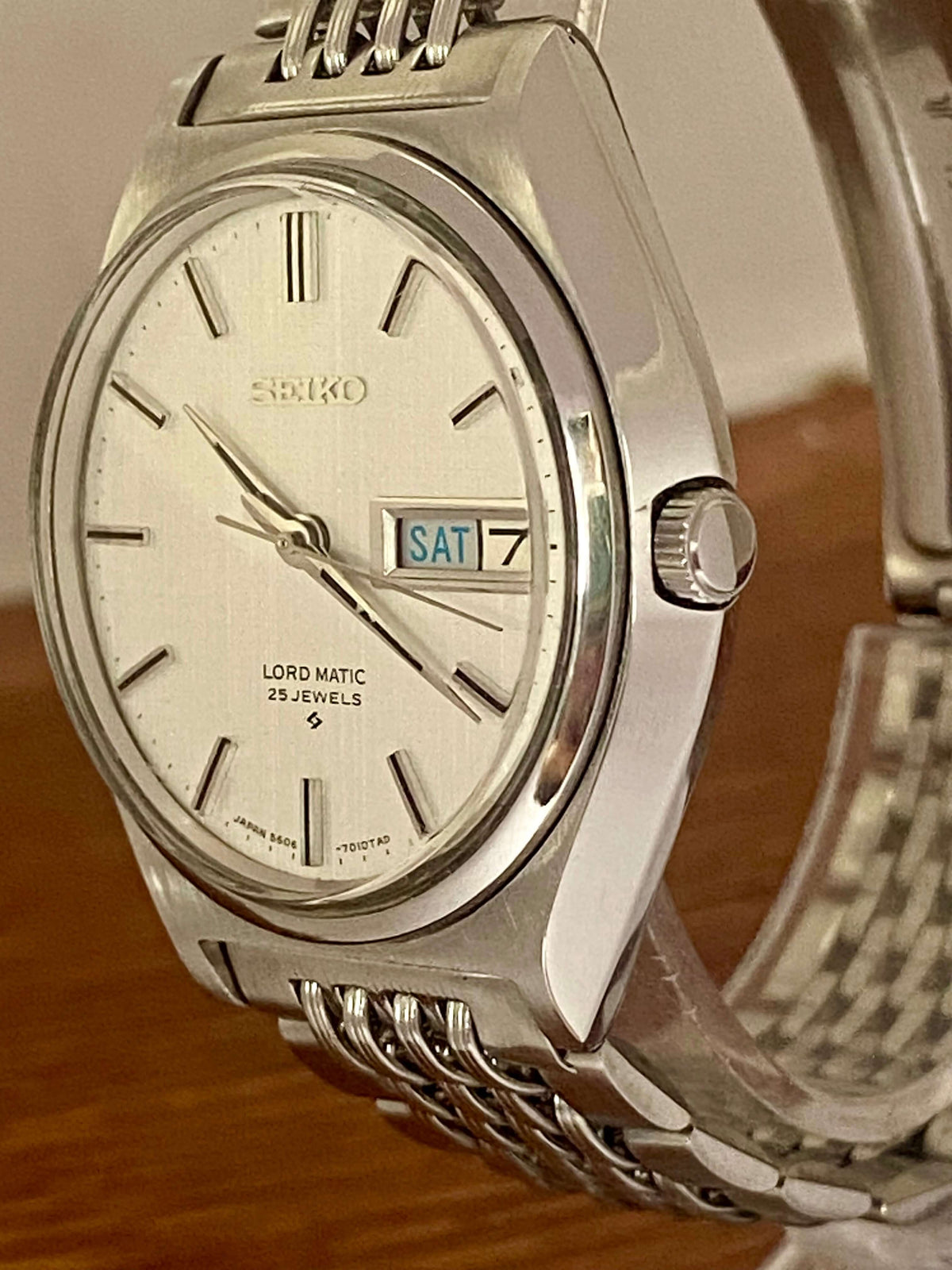 Vintage Seiko Lord Matic 5606-7010 watch featuring original white linen dial and automatic movement.