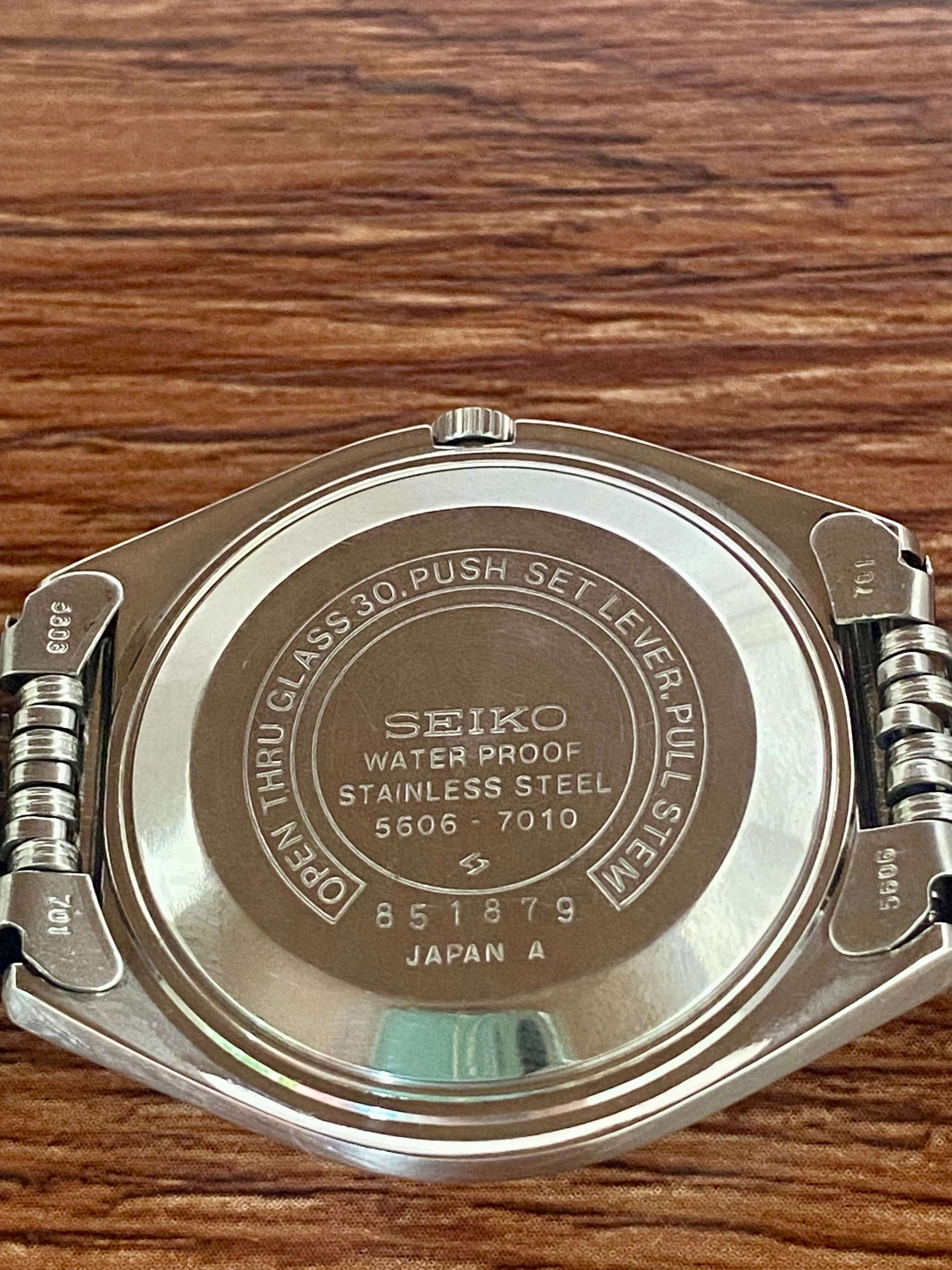 Vintage Seiko Lord Matic 5606-7010 stainless steel back showcasing waterproof features and serial number 851879.