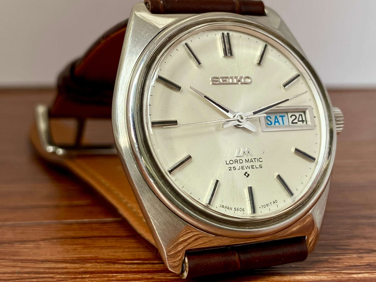Vintage Seiko Lord Matic 5606-7000 watch with original dial and bilingual day-date feature.
