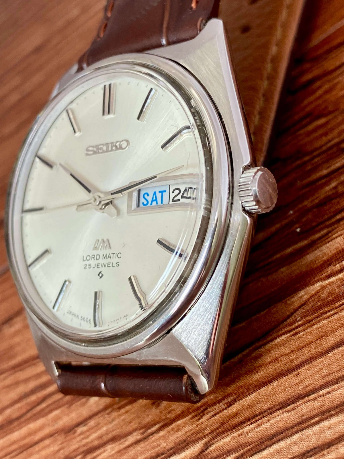 Vintage Seiko Lord Matic 5606-7000 watch showing bilingual day/date and original dial in great condition.