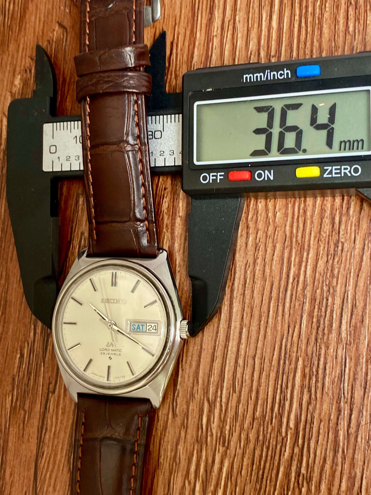 Vintage Seiko Lord Matic 5606-7000 being measured for size with calipers, showcasing its elegant design and craftsmanship.