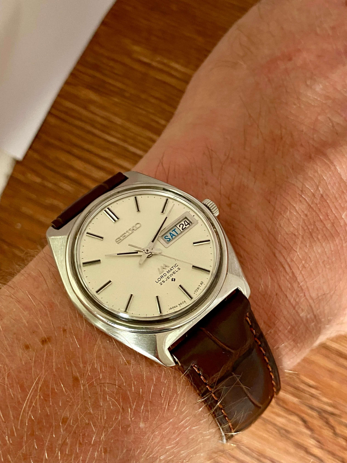 Vintage Seiko Lord Matic 5606-7000 on wrist showcasing original dial and leather strap.
