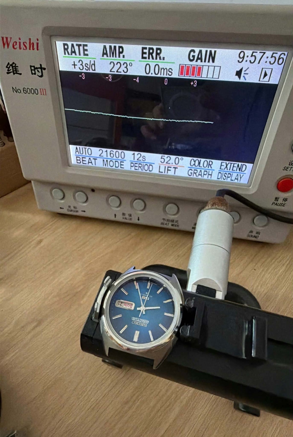 Seiko 5 Actus SS 6106-8670 on testing equipment showing blue dial and performance metrics.