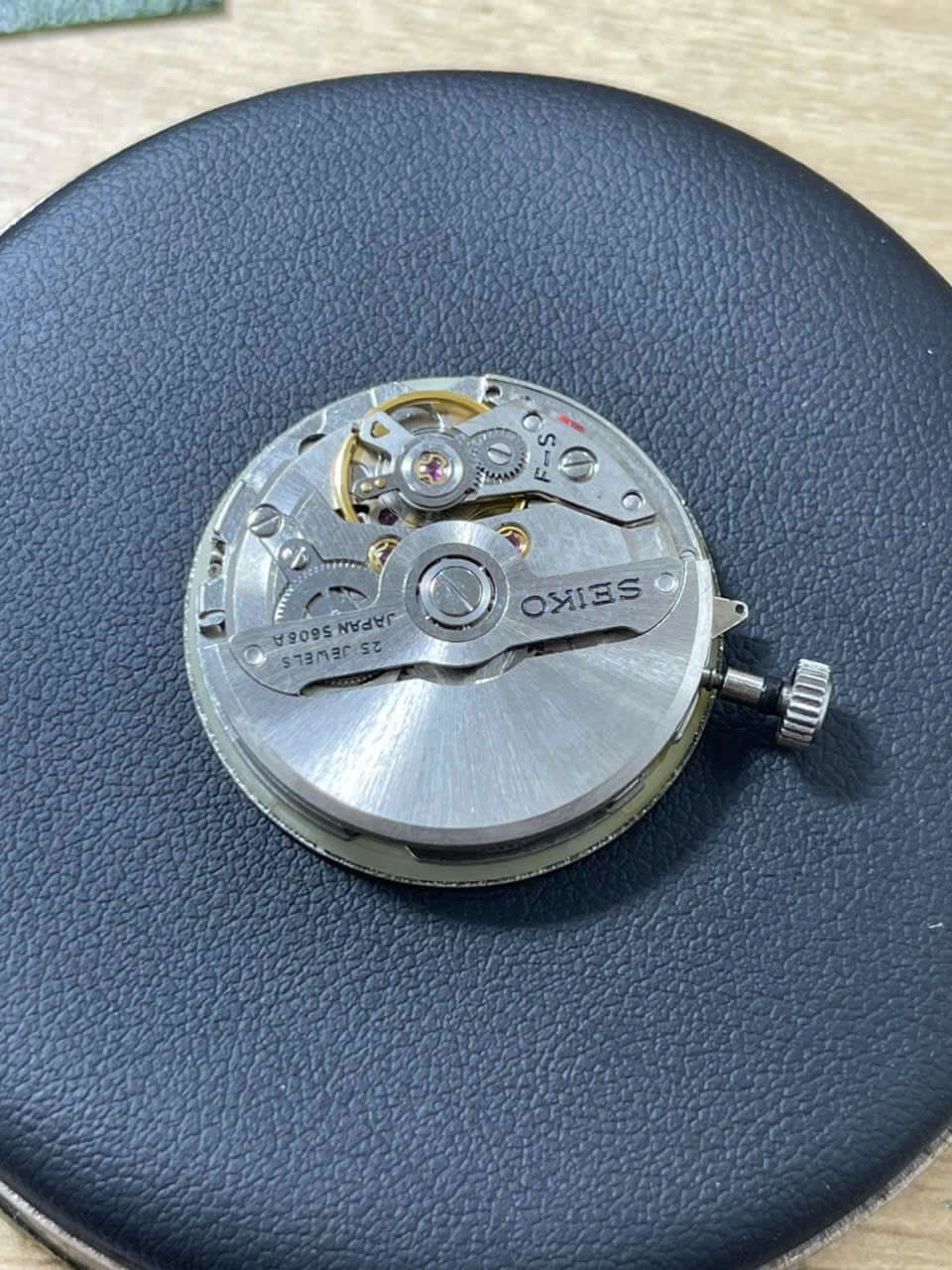 Vintage Seiko Lord Matic 5606-7000 watch movement, highlighting intricate mechanics and craftsmanship.